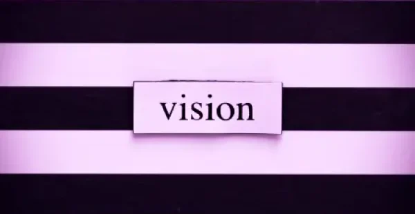 Das Wort Vision steht auf einem schwarz-weiß gestreiften Hintergrund.